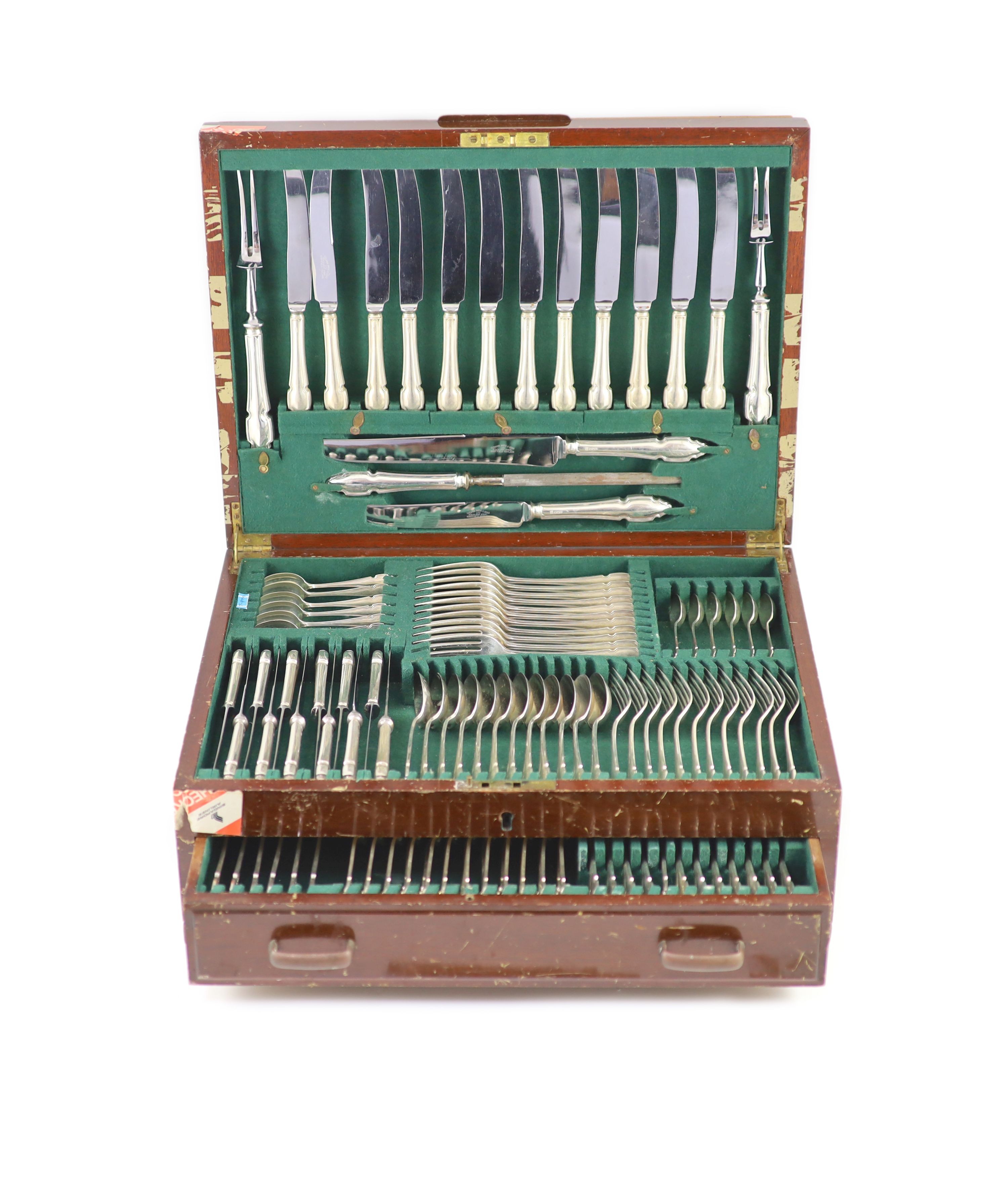An almost complete canteen of silver Chippendale pattern cutlery for twelve, by Cooper Brothers & Sons